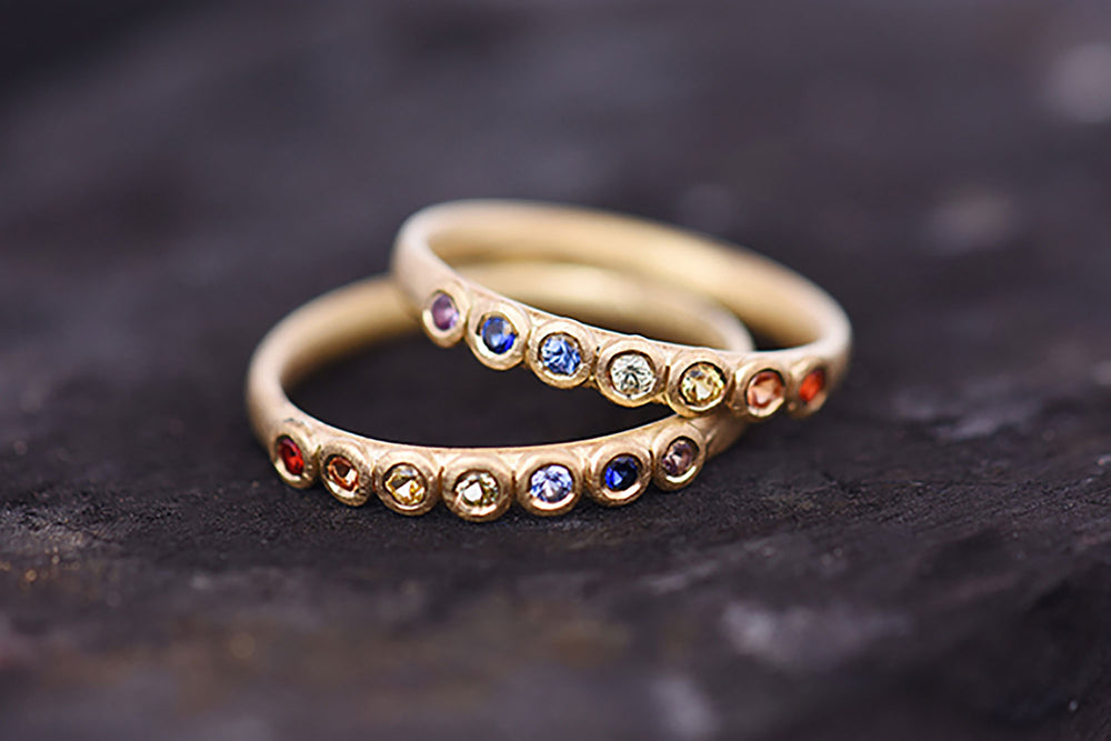 Rainbow sapphire Eternity rings. Made by Goodman Morris.
