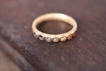 Large rainbow sapphire eternity ring made by Goodman Morris.