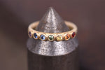 Large rainbow sapphire eternity ring. Made by Goodman Morris.
